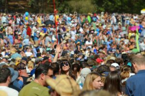 a crowd of people with one person holding up their hand