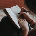 photo of someone writing in a journal